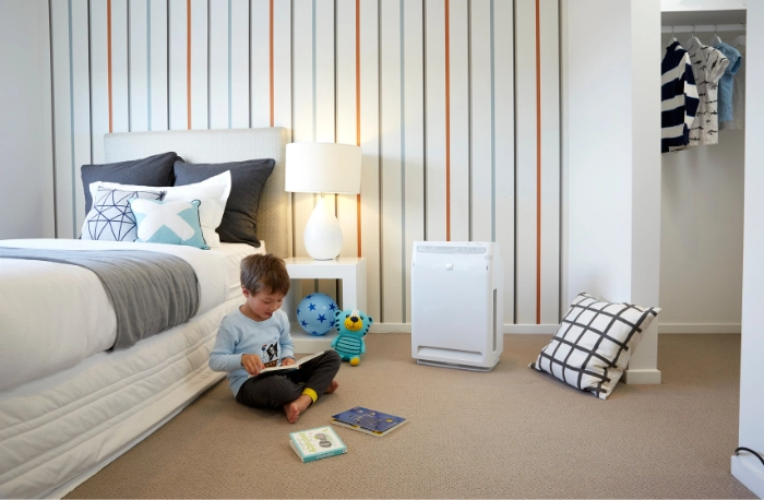 Boy reading beside the bed